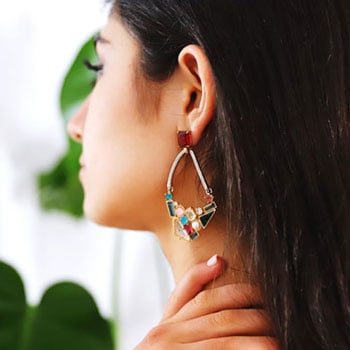 f-young-woman-looking-at-the-mirror-and-wearing-earring-floral-jewelry-for-women-fjw