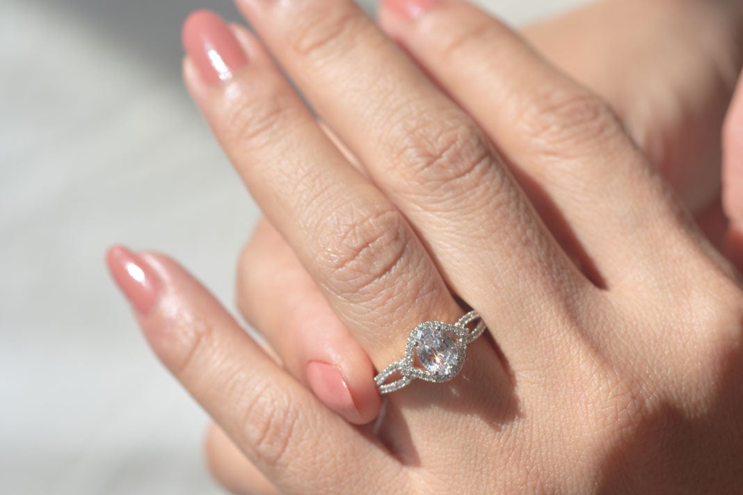 close-up-view-of-diamond-ring-and-woman-hand-nerw